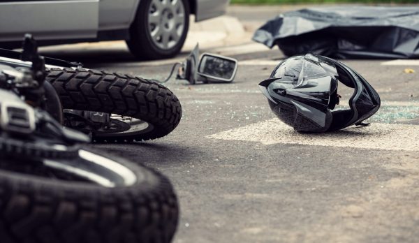 Motorcycle and helmet on the street after dangerous traffic incident